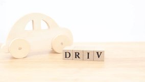A wooden car and DRIVE letter blocks. A piece that evokes driving and car life. - Powered by Shutterstock - Get 15% off with code: PIKWIZARD15