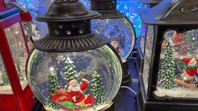 Beautiful christmas snow globes and musical lanterns glowing in a store. Shiny glitter swirls around santa claus, snowman, and reindeer figures, creating a magical winter wonderland scene - Powered by Shutterstock - Get 15% off with code: PIKWIZARD15