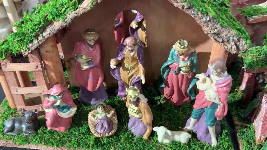 Christmas holiday decorations showing multiple nativity scenes with the holy family, baby jesus in a manger, the three wise men, shepherds, and animals in a detailed miniature village setting