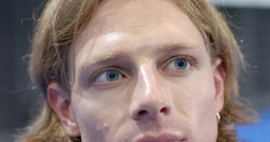 Man tilting head right in tech demo activating golden streak flowing across face for glitch effect. Futuristic, digital, holographic, minimalism, technology, innovation, abstract