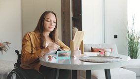 Young woman enjoying self-care while applying makeup at home in a wheelchair, promoting happiness, inclusivity, and disability awareness during her daily routine - Powered by Shutterstock - Get 15% off with code: PIKWIZARD15