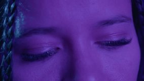 A close-up shot of a person's closed eyes with vibrant purple lighting, enhancing the serene and introspective mood. Detailed focus on eyelashes and skin texture. - Powered by Shutterstock - Get 15% off with code: PIKWIZARD15