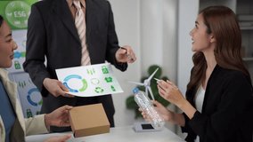Business people meeting in an office discussing sustainable packaging and recycling solutions - Powered by Shutterstock - Get 15% off with code: PIKWIZARD15