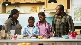 Parents and children sprinkling mozzarella and grated cheese on homemade pizza dough, laughing in the kitchen together in this family moment filled with joy and culinary creativity. Camera B. - Powered by Shutterstock - Get 15% off with code: PIKWIZARD15
