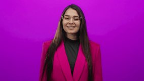 Hispanic woman in pink jacket makes come here gesture against vibrant pink background. - Powered by Shutterstock - Get 15% off with code: PIKWIZARD15