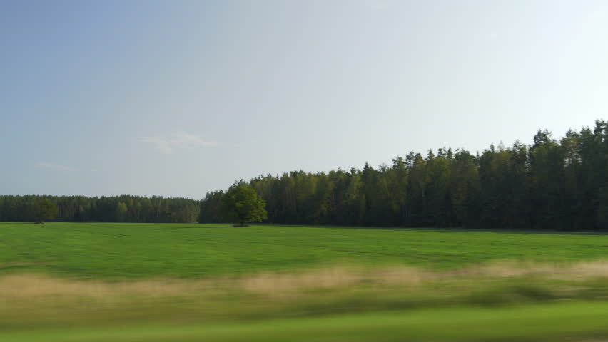 sunny summer day farmers green field forest background landscape passenger side window pov panorama 4k
