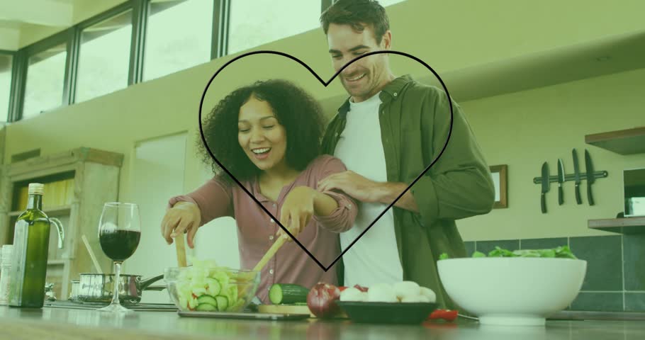 Woman tossing salad in kitchen initiating neon heart graphic around couple celebrating meal prep. Romance, intimacy, culinary, modern, lifestyle, affection, partnership