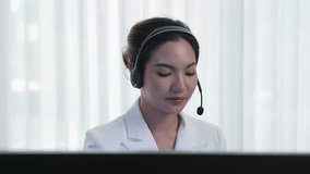 Businesswoman wearing vivancy headset working in office to support remote customer or colleague. Call center, telemarketing, customer support agent provide service on telephone video conference call - Powered by Shutterstock - Get 15% off with code: PIKWIZARD15