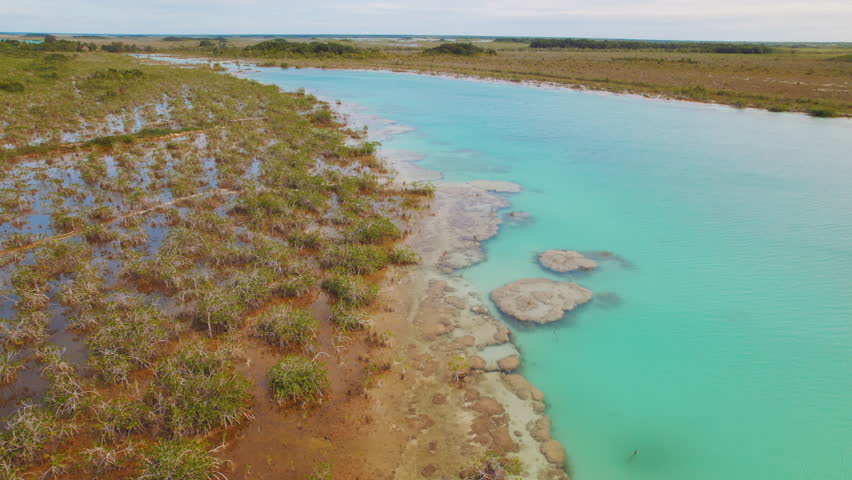 Aerial of turquoise water channel with stromatolites in Bacalar lagoon Mexico