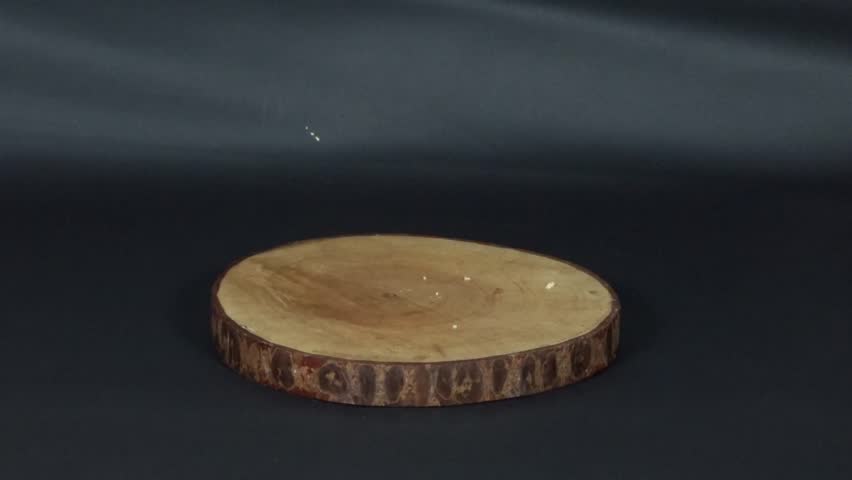 A person placing a soft sponge piece on a wooden board, ideal for dessert, texture, or bakery themes.
