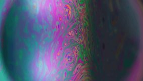 Vertical video. Gasoline defocused fluid. Mystical paint. Colorful emulsion oil dye mix sphere. Pink green cosmic background black space glowing frame. - Powered by Shutterstock - Get 15% off with code: PIKWIZARD15