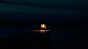 A burning kerosene lantern on a wooden bridge at night on the shore of a frozen lake. Silence on a frosty night.	 - Powered by Shutterstock - Get 15% off with code: PIKWIZARD15