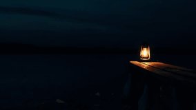 A burning kerosene lantern on a wooden bridge at night on the shore of a frozen lake. Silence on a frosty night.	 - Powered by Shutterstock - Get 15% off with code: PIKWIZARD15