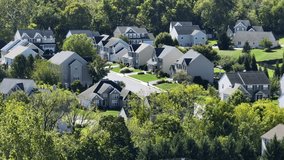 Modern Single Family houses in green suburb neighborhood. Sunny day in fall season. Aerial wide shot. Calm and peaceful housing area of USA. - Powered by Shutterstock - Get 15% off with code: PIKWIZARD15