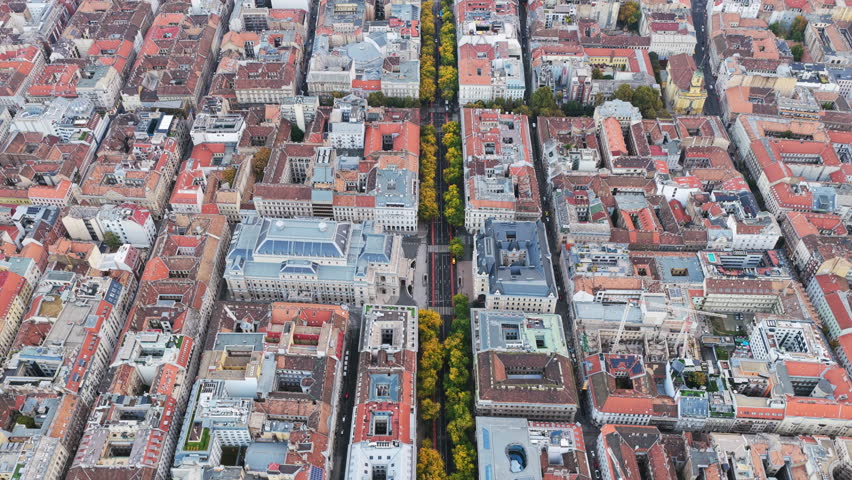 Aerial view of Budapest’s city grid showing Andrássy Avenue lined with trees, surrounded by historic buildings with terracotta rooftops and classic architecture.