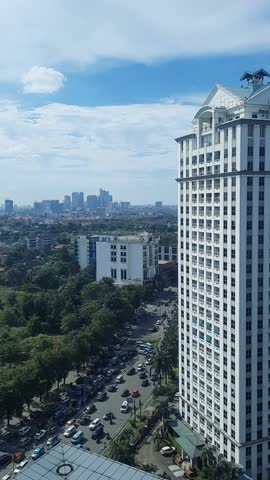 Vehicles and motorcycles crowd the streets during rush hour, showcasing the busy urban lifestyle at Jakarta, Indonesia.