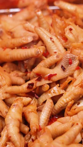 Traditional Asian delicacy of chicken feet cooked in spicy sauce with aromatic spices, representing exotic street food culture, bold flavors, and authentic regional culinary tradition.
