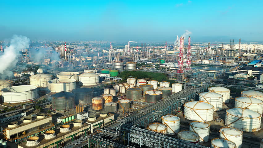 Aerial shot of an oil refinery and chemical plant with storage tank in a large industrial area
