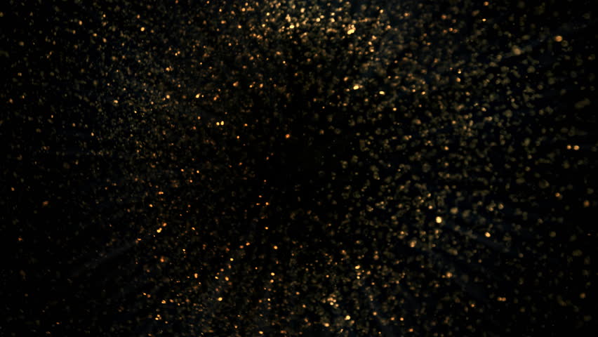 Super Slow Motion Shot of Rotating Golden Glitters Towards Camera Isolated on Black 1000fps.