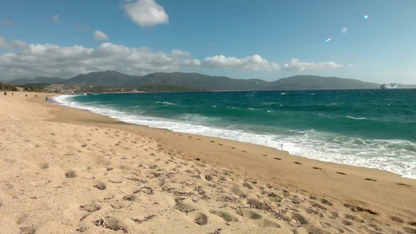 Scenic beach landscape with turquoise water and mountains under a blue sky day