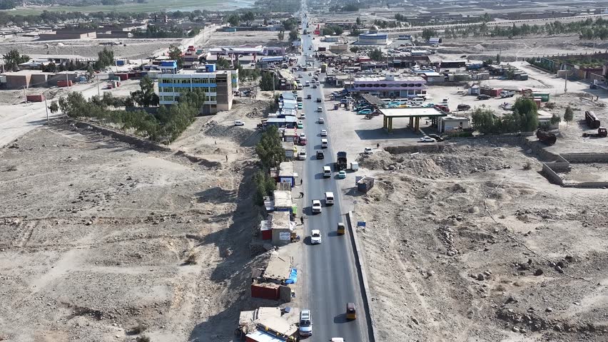 Rural Drone Aerial View of Village road Street Traffic with old school traditional tuktuks or rickshaws, Nangarhar, Afghanistan. Building Reconstruction after war