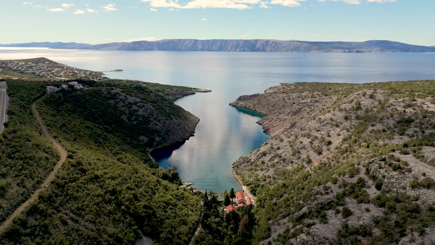 Aerial Drone View of Wild Croatian Landscapes. Rugged coastline, untouched forests, green hills and the deep blue Adriatic Sea creating breathtaking natural scenery from above