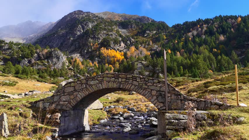 aerial view of Andorra valley in autumn, beautiful nature of Andorra, Vall del Riu in Andorra, a medieval bridge and river in the mountains of Andorra.