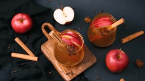 Warm apple cider with cinnamon sticks and star anise on dark background with apples - Powered by Shutterstock - Get 15% off with code: PIKWIZARD15