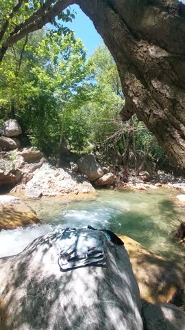 A peaceful moment along Karaçay stream in Osmaniye, Turkey. The clear water flows gently between the stones as sunlight filters through the trees. A natural escape that highlights the untouched beauty