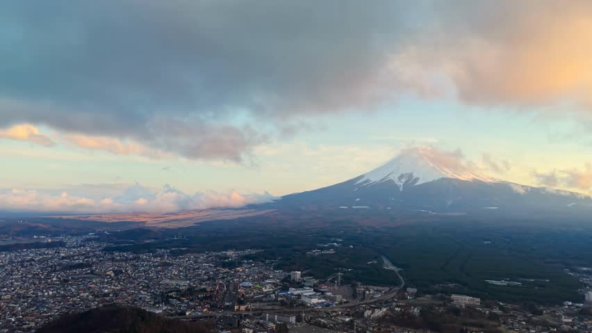 Aerial drone footage of Fujikawaguchiko Town in Japan at the foothills of Mount Fuji, showcasing scenic landscapes, traditional town architecture, and natural beauty.