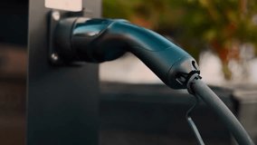 Close-up shot of an electric car charging at a modern station, showing green energy technology, sustainability, and the future of eco-friendly transportation. - Powered by Shutterstock - Get 15% off with code: PIKWIZARD15