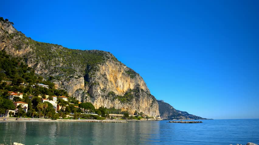 Scenic view of Petite Afrique Beach in Beaulieu-sur-Mer, France, showcasing turquoise waters, sandy shores, and Mediterranean coastal beauty.
