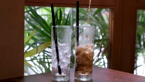 Closeup of pouring cola drink with ice cubes. Fizzing cola with ice in glass. Refreshing tasty cola drink. - Powered by Shutterstock - Get 15% off with code: PIKWIZARD15