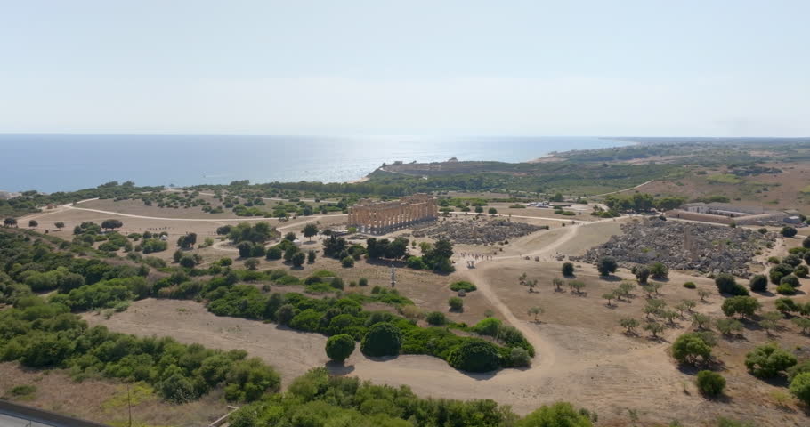 Aerial view of the Temple of Hera located at the archaeological site of Selinunte, in the province of Trapani, Sicily, Italy. The Mediterranean Sea appears on the horizon in the background.