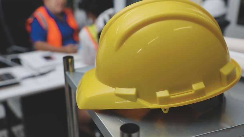 team of multiethnic architects working on construction plans in meeting room engineers discussing on project in office mature businessman and woman standing around table working on blueprint no logos