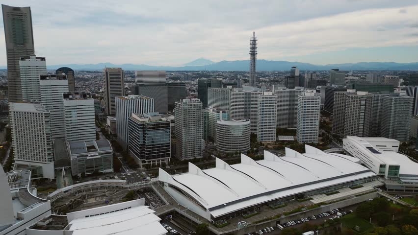 Slow forward drone flight revealing Yokohama skyline and Mount Fuji