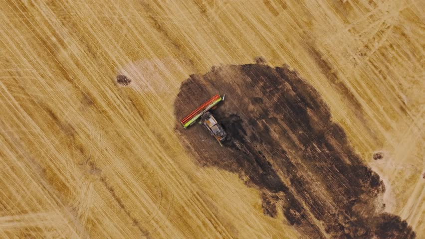 Epic cinematic drone, ruined machine in field reflecting hardship, farmer crisis