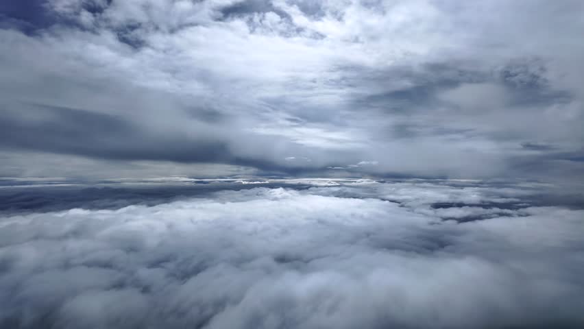 immersive pilot’s perspective from the cockpit of a jet airplane flying between endless layers of darkening stratus clouds