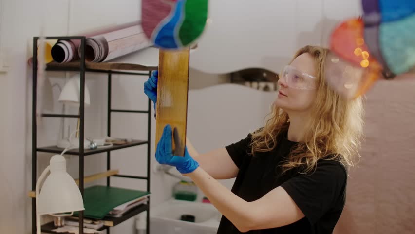 Female Stained glass artisan creates handmade art, women in DIY