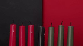 African American Kwanzaa holiday concept with traditional lit candles. Seven candles red, black and green - Powered by Shutterstock - Get 15% off with code: PIKWIZARD15