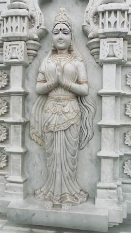 Intricately carved marble relief depicting a standing Hindu goddess in elegant posture, showing detailed craftsmanship.