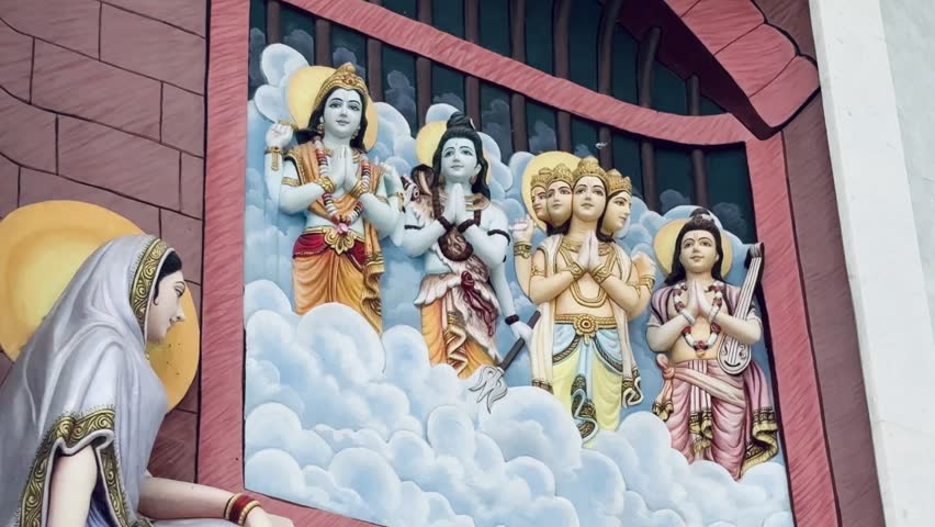 Lord Brahma, Lord Vishnu, and Lord Shiva — seated among divine clouds, symbolizing creation, preservation, and destruction. The vibrant relief artwork showcases exquisite craftsmanship, spiritual