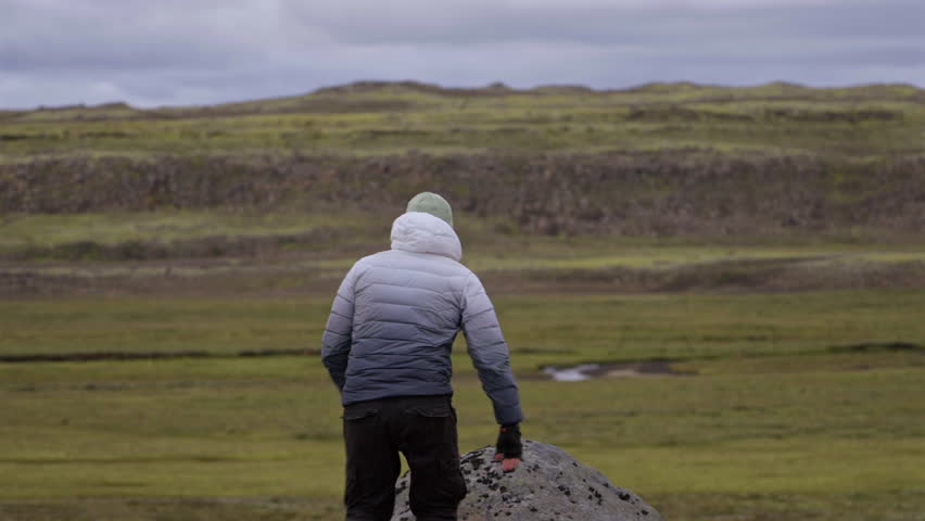 Traveler Standing on Rock in Icelandic Highland Landscape