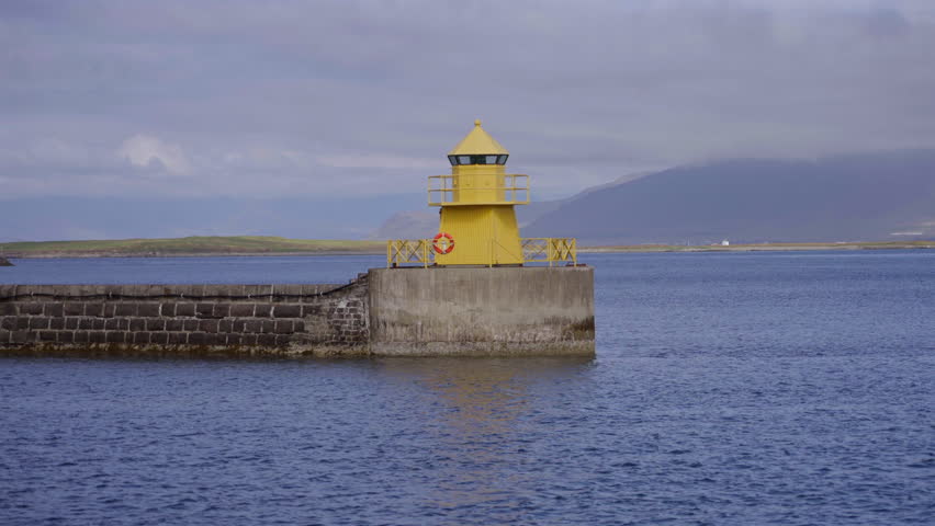 Yellow Lighthouse on Concrete Pier