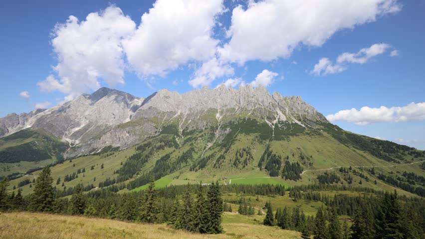Hochkönig mountain ridge in Austria. Alps mountains landscape. Austrian Alps in Salzburg region Salzburger almenweg hiking trail scenic video timelapse of clouds moving above summits