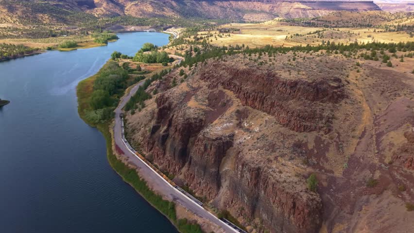 A stunning aerial photograph capturing the Pelton Regulating Dam and its reservoir, a key component of the Pelton Round Butte Hydroelectric Project on the Deschutes River