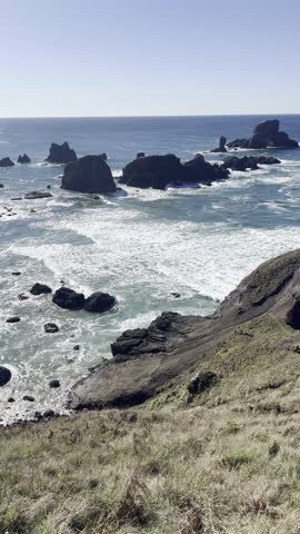 A breathtaking aerial panorama capturing the curved coastline of Crescent Beach, framed by dramatic cliffs and forest, as seen from the elevated Ecola Point Viewpoint on the Oregon Coast
