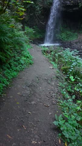 A beautiful view of Bridal Veil Falls, a distinctive two-tiered waterfall with a wispy, veil-like appearance, located near the historic Bridal Veil Falls State Scenic Viewpoint in the Columbia River G