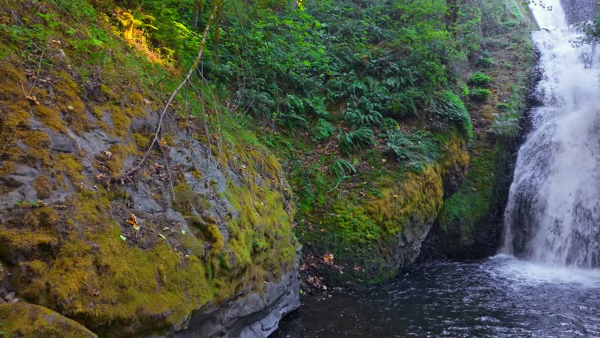 A beautiful view of Bridal Veil Falls, a distinctive two-tiered waterfall with a wispy, veil-like appearance, located near the historic Bridal Veil Falls State Scenic Viewpoint in the Columbia River G