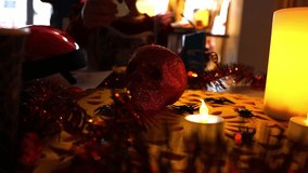 People sitting at a Halloween-themed table eating spooky snacks, with a decorative skull and burning candles creating a dark festive atmosphere. Warm candlelight and horror-style decorations captured  - Powered by Shutterstock - Get 15% off with code: PIKWIZARD15